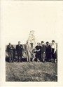 Image - Photograph of a group of people in front of a cairn